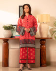 2 piece printed cambric suit – bold burnt red kurta with black and multicolor border, paired with matching trousers.