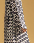 A close-up of a women's printed kaftan, showing the fabric pattern and the V-neck design