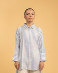 A close-up of a women's striped shirt, focusing on the classic collar and fabric texture.