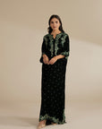 Bottle green velvet kaftan shown in full length with embroidered neckline for a winter festive look.