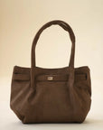 Brown slouchy handbag with long shoulder handles and a soft, roomy silhouette in studio lighting