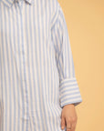 Casual outfit featuring a striped long shirt and white trousers, a perfect modern Pakistani style