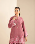 Close-up embroidery detail on pink khaddar shirt front