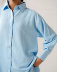 Close-up of a premium ladies poplin shirt, showing the smooth, woven texture and clean lines of the durable cotton fabric