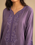 Close-up of light purple linen suit neckline featuring delicate embroidery detailing on the front
