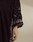 Close-up of velvet kaftan sleeve featuring gold embroidered detailing on the cuff
