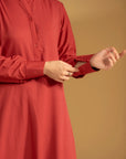 Detailed view of the button placket and band collar on a classic maroon kurta for women.