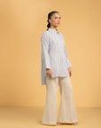 Detailed view of the wide, folded cuff on a stylish blue and white striped shirt