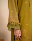 Embroidered sleeve detail with lace trim and velvet tassel