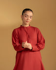 Full-length shot of a model wearing a maroon kurta, highlighting the straight cut and relaxed fit.
