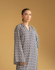 Full-length view of a modern kaftan with a black and white pattern, perfect for a modest look in Pakistan.