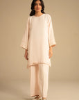 Full front view of peach embroidered kurta set styled minimal for an elegant everyday look.