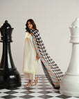 Vibrant black and white printed dupatta cascading over ivory self embroidered lawn outfit seasonal daywear styling