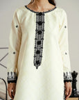 Printed monochrome dupatta draped over white lawn kameez with contrast black stitchwork detailing Beyond East