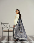 Rear angle of white lawn kameez highlighting black embroidered back panel and dupatta fall styling Beyond East