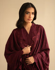 Mid-shot of model in maroon embroidered linen suit highlighting neckline and front embroidery placement.