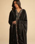 Model in black linen embroidered suit holding dupatta, showcasing pastel embroidery on kurta front