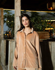Model in camel velvet co-ord set standing outdoors, front pose highlighting velvet sheen.