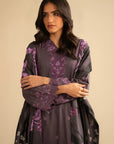 Model in purple embroidered linen suit with printed shawl, front pose highlighting embroidery placement