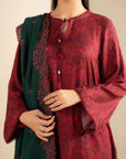 Model wearing Marina suit — wine red long kurta with full sleeves and contrasting forest green dupatta with embroidered border.