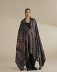 Model wearing grey printed herringbone shawl with intricate pattern drape, full front view in studio setting