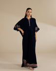 Navy velvet kaftan with embroidered neckline and hem border, shown as a full-length studio look.