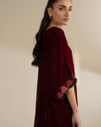 Side angle highlighting the drape of the maroon kaftan and sleeve shape.