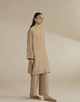 Side pose of minimalist beige kurta and trouser set for women, soft blended fabric.