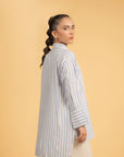 Side view of a striped high-low hem shirt, highlighting the relaxed fit and silhouette