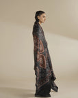 Side view of grey printed shawl wrapped around shoulders, showing overall length and border design