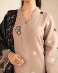 Sleeve embroidery detail on khaddar suit in skin color with black accents