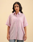 Soft pink tailored shirt for women – chic and comfortable fashion staple.