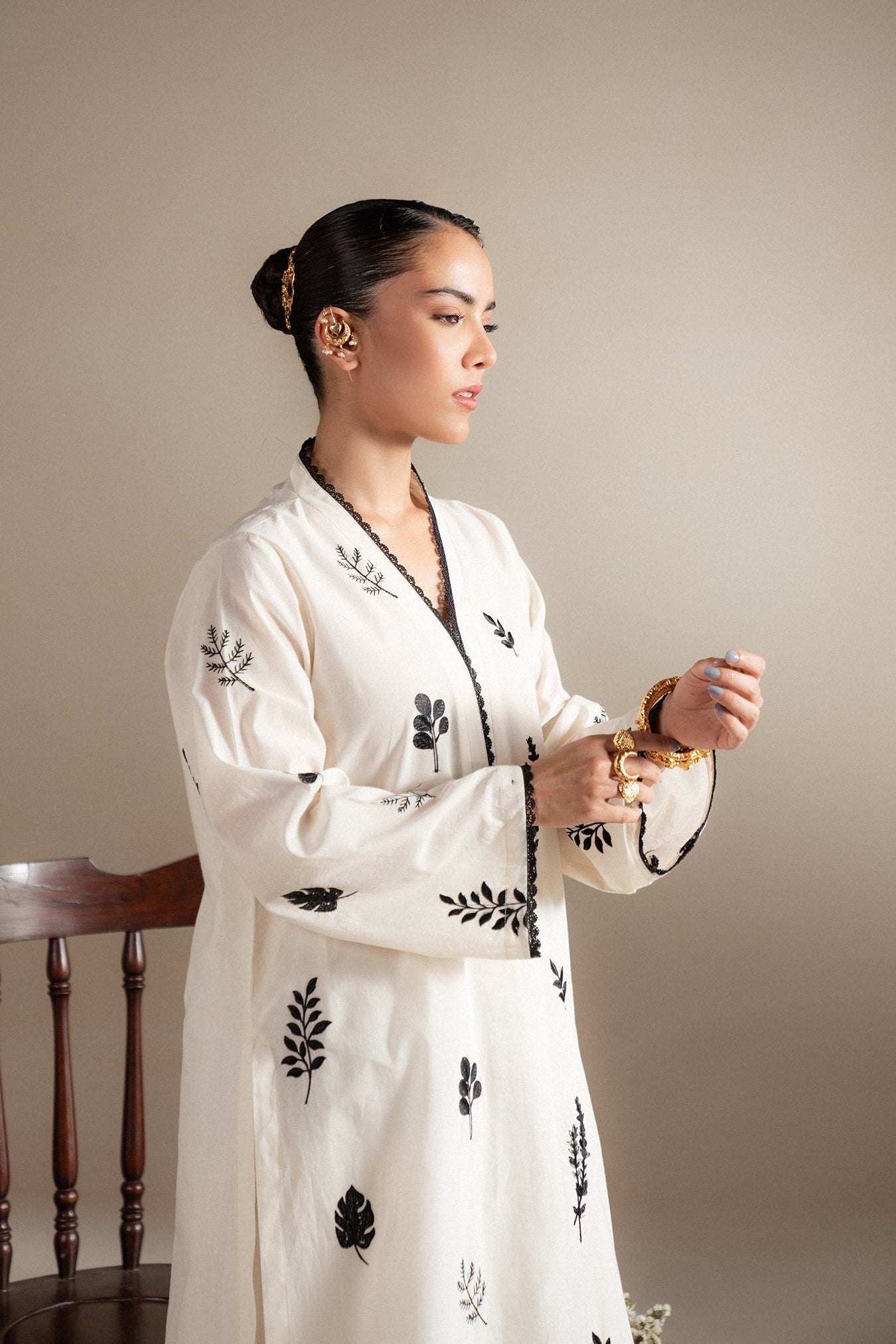 Stitched monochrome lawn outfit for women featuring black floral embroidery on cream base