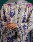 Trending lawn suits in Pakistan – a grey floral printed lawn set with a statement ikkat dupatta in purple hues, perfect for casual wear.