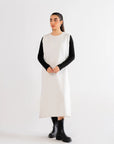 White maxi dress styled with black details, showcasing a versatile and trendy outfit idea.