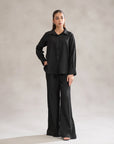 Black co ord set for women with wide-leg pants and shirt – minimalist cord set dress trend in Pakistan.
