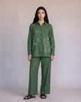 A woman wearing an olive green embroidered co-ord set with a button-front kurta top and matching wide-leg trousers, styled with brown kolhapuri sandals — Beyond East Fall Winter 2026 Pakistani fashion