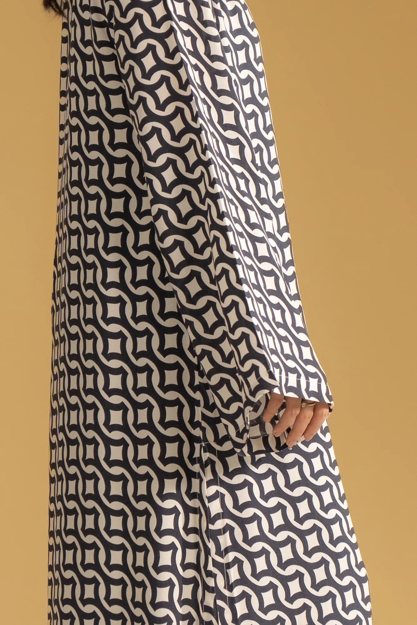 A close-up of a women's printed kaftan, showing the fabric pattern and the V-neck design