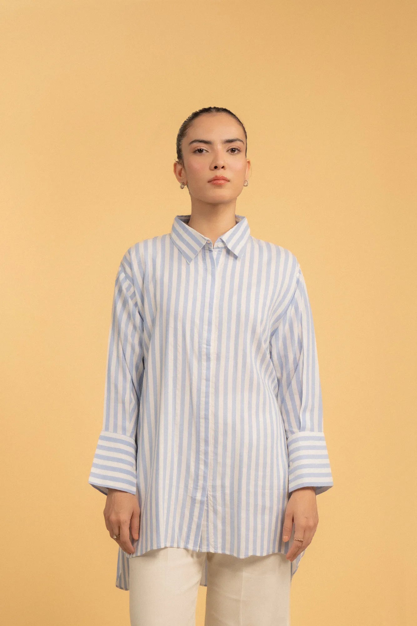 A close-up of a women's striped shirt, focusing on the classic collar and fabric texture.