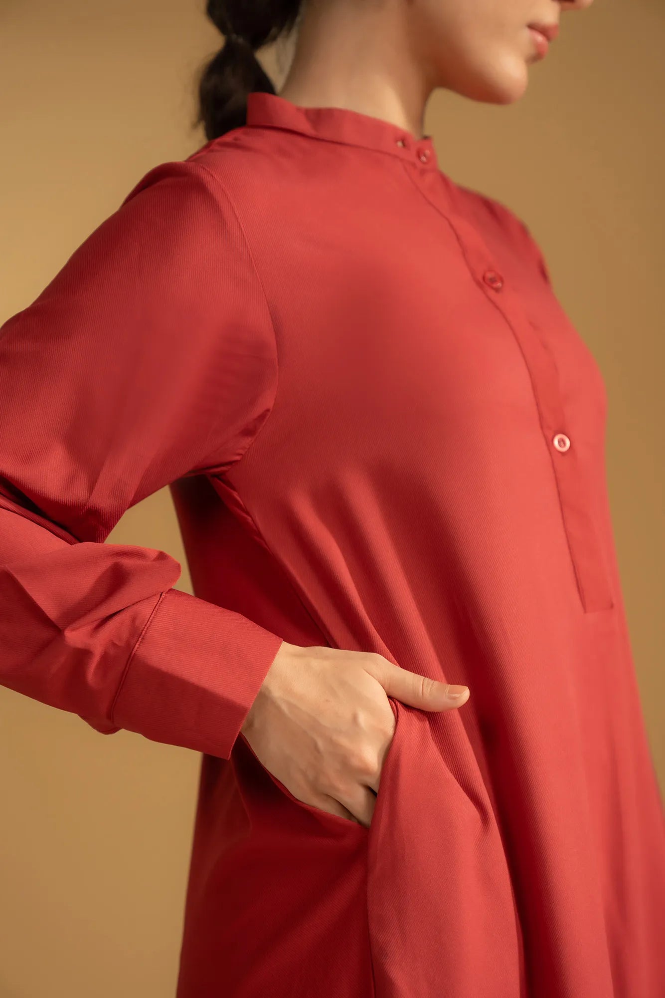 A maroon cotton kurta with a band collar, styled for a casual, elegant look.