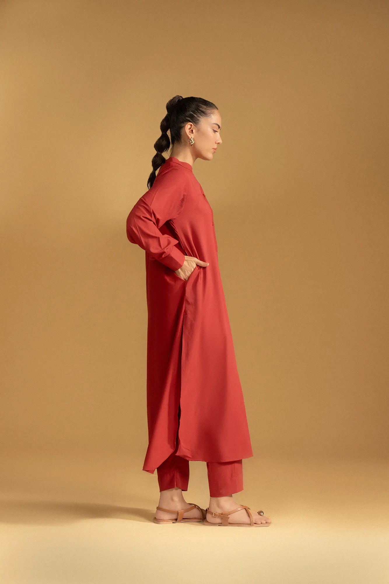 A versatile maroon women's kurta perfect for pairing with trousers or leggings for a traditional outfit.