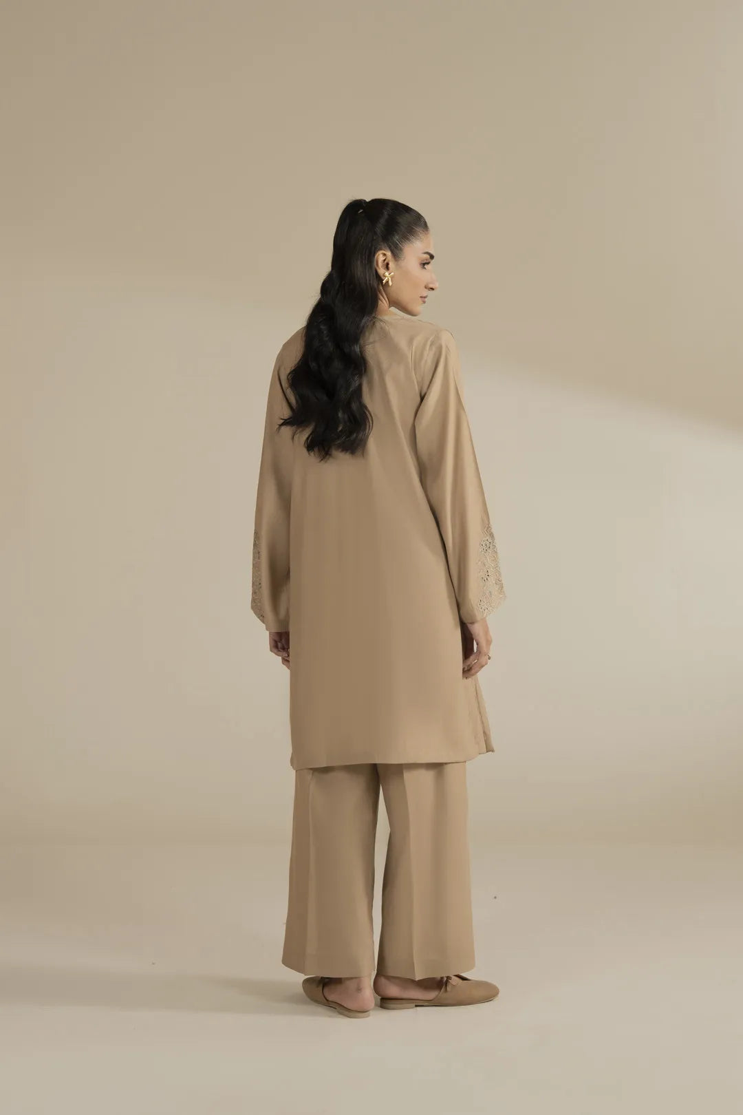 Back angle of beige 2 piece suit showing relaxed silhouette and clean finish.