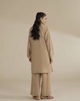 Back angle of beige 2 piece suit showing relaxed silhouette and clean finish.