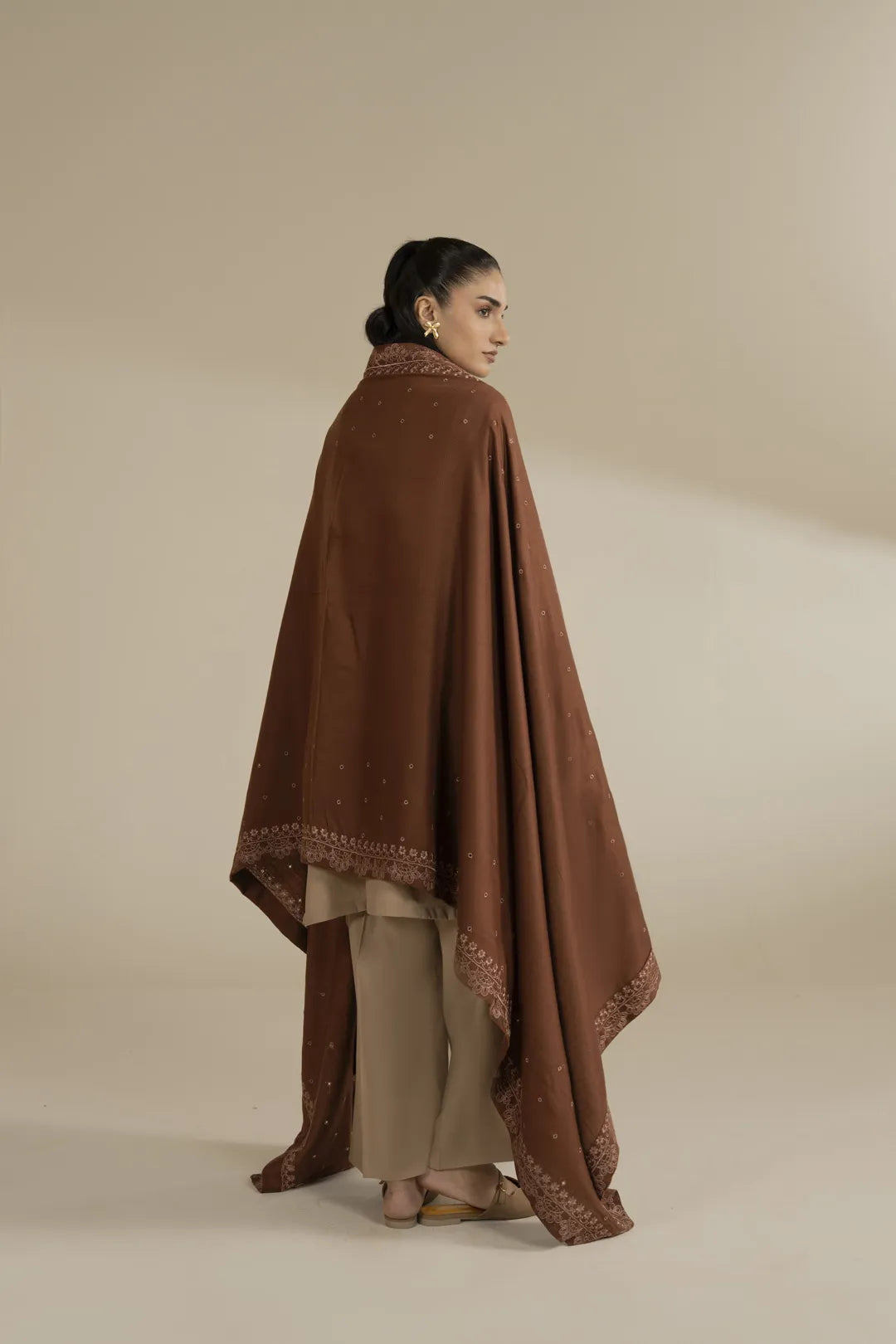 Back/side angle showing shawl length and flow, highlighting the warm brown tone and coverage.