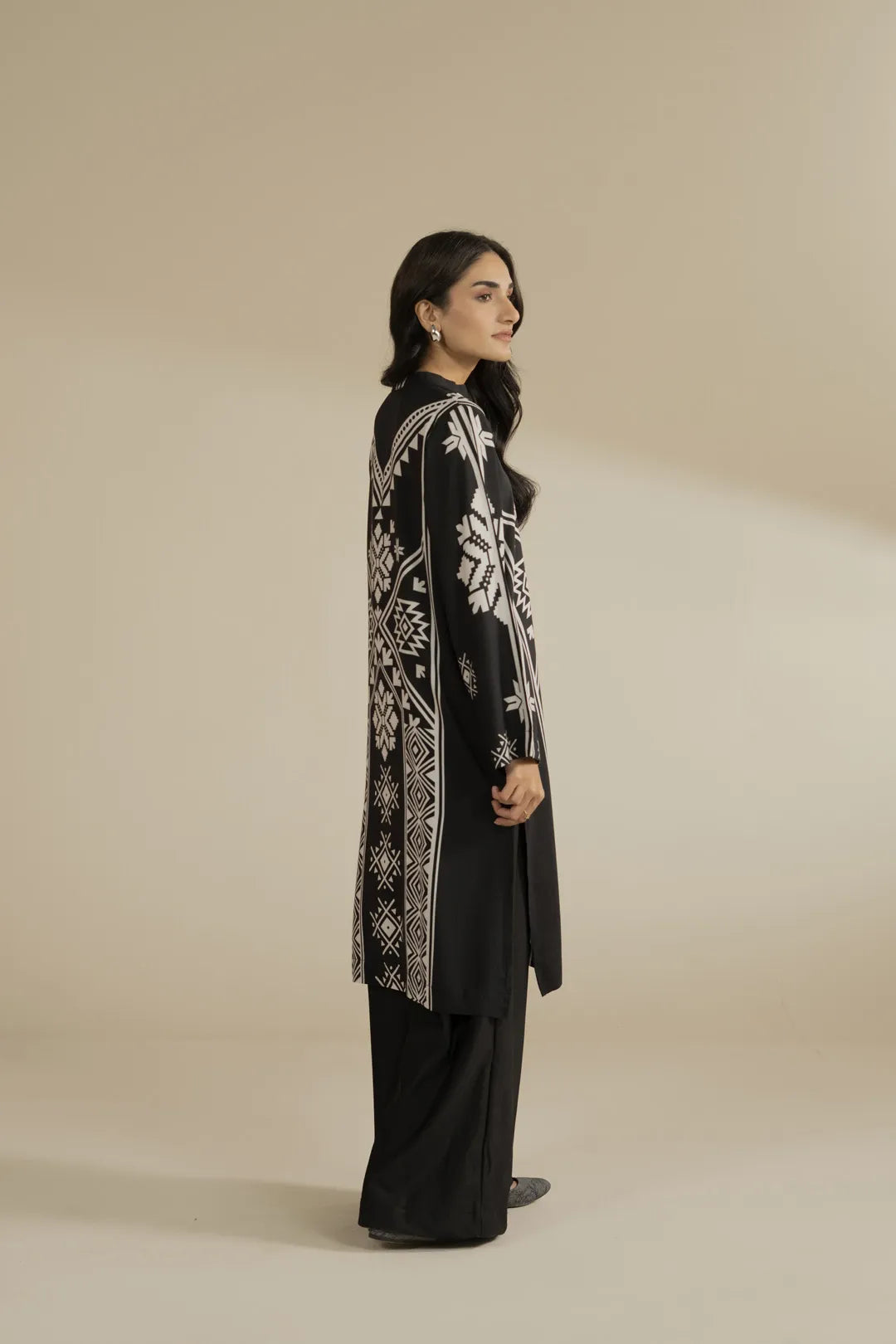 Back/three-quarter view highlighting the fall and length of the printed linen shirt outfit