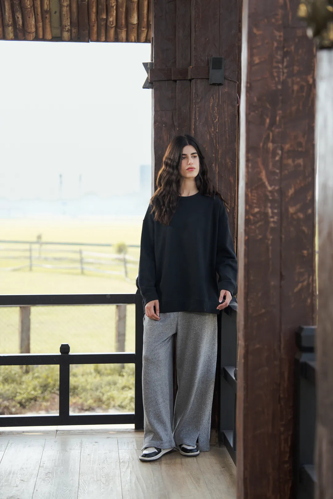 Back view of black sweatshirt drape and shoulder fit