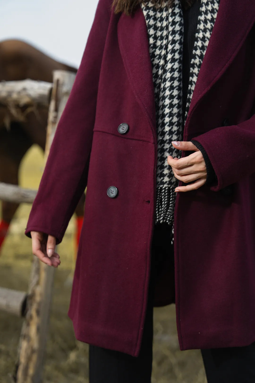 Back view of maroon winter coat for women, knee-length hemline