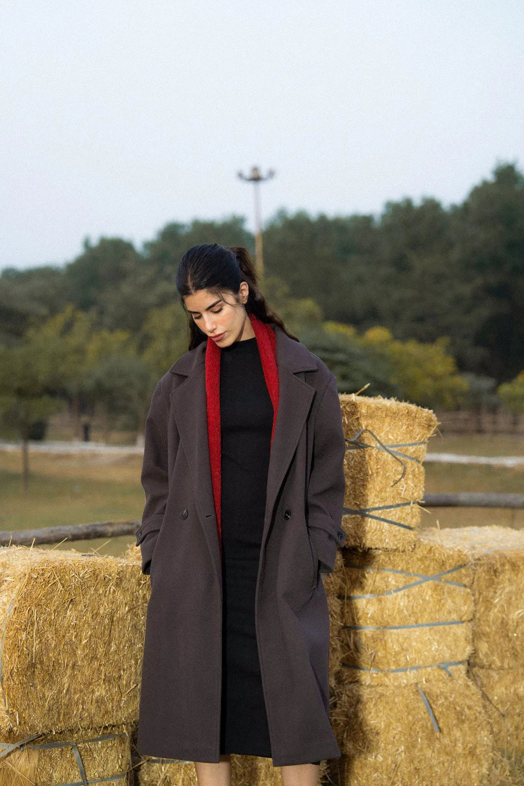 Back view of women’s long overcoat in dark grey, winter styling