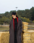 Back view of women’s long overcoat in dark grey, winter styling