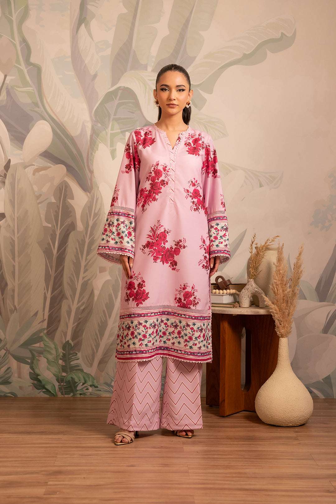 Best 2 piece printed cambric suit – elegant light pink kurta with floral prints, paired with a stylish zigzag patterned trouser.